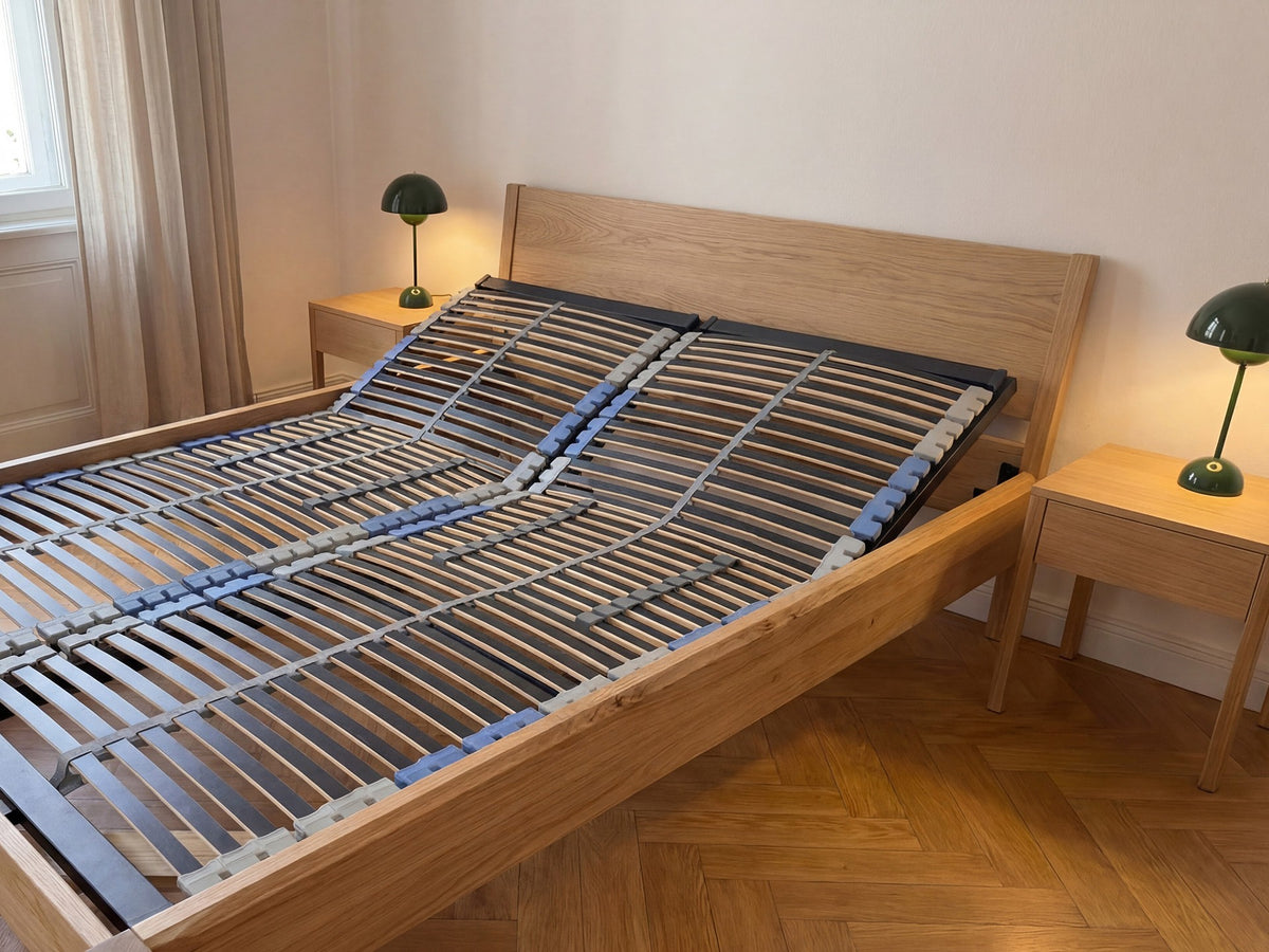 Modernes Holzbettgestell mit verstellbarem Lattenrost in einem hellen Schlafzimmer mit zwei Nachttischen und grünen Lampen